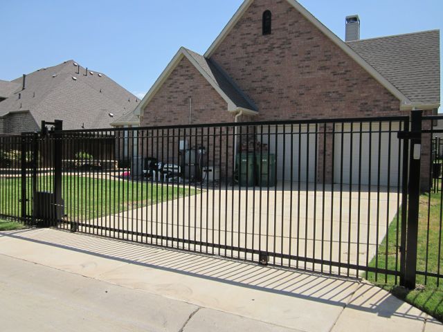 Iron sliding driveway gate with operator installed by Fence Guy