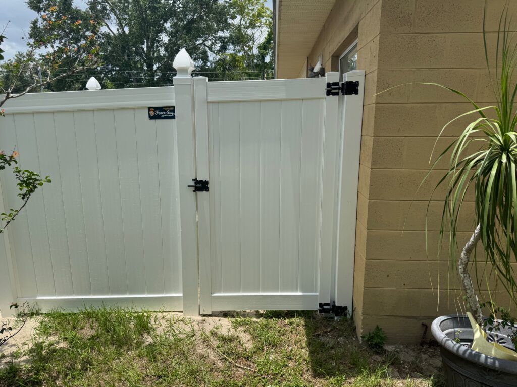 White vinyl privacy fence and gate installed by Fence Guy
