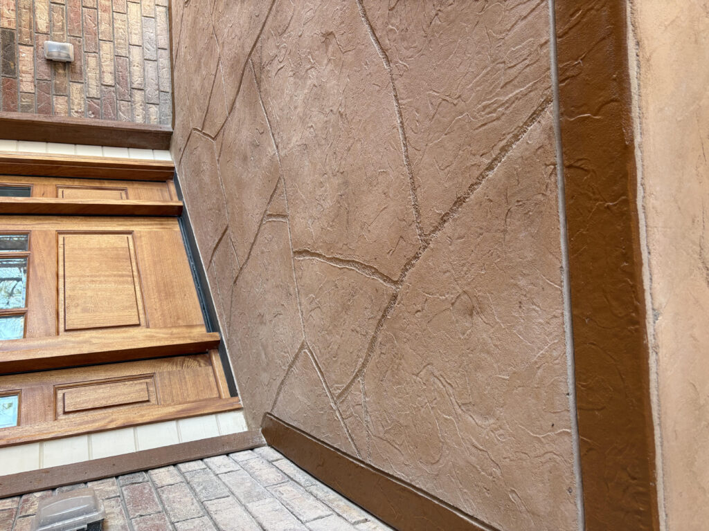 Stamped concrete with flagstone texture by Fence Guy